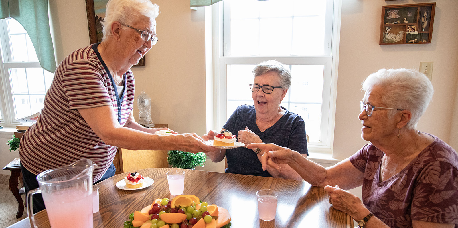 three ladies eating afternoon snacks