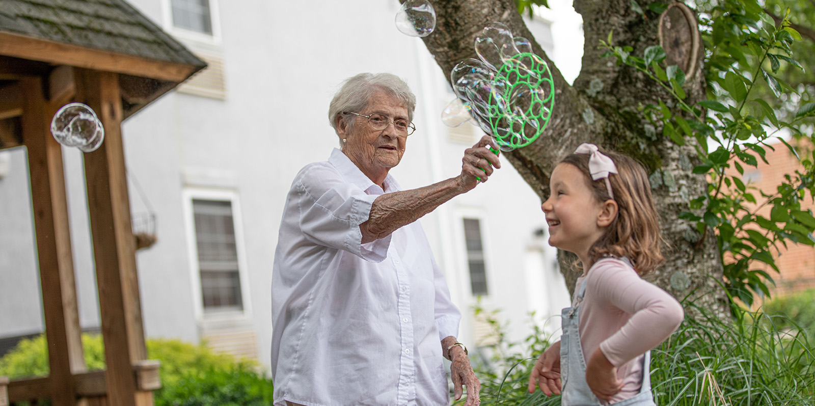 Grandmother and grandchild playing with bubbles