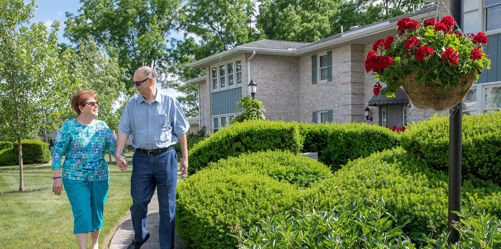 Couple Walking in Front of Courtyard Apartments 